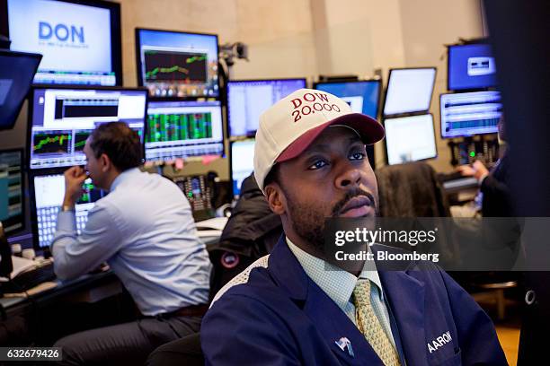 Trader wearing a "DOW 20,000" hat works on the floor of the New York Stock Exchange in New York, U.S., on Wednesday, Jan. 25, 2017. The Dow Jones...