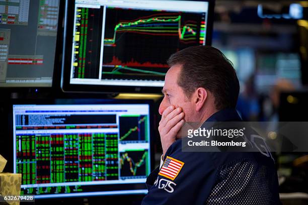 Trader works on the floor of the New York Stock Exchange in New York, U.S., on Wednesday, Jan. 25, 2017. The Dow Jones Industrial Average climbed...