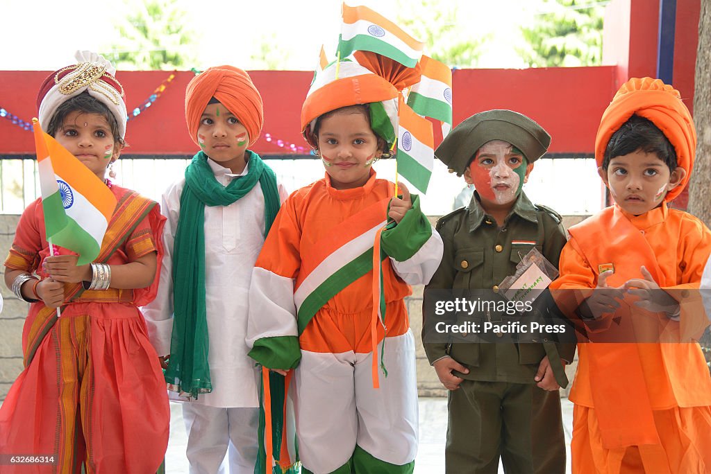 Children wearing orange and green theme traditional dress...