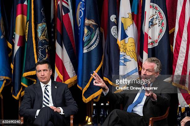 Nevada Governor Brian Sandoval looks on as Virginia Governor Terry McAuliffe speaks during a 'State of the States' event at the Newseum, January 25,...