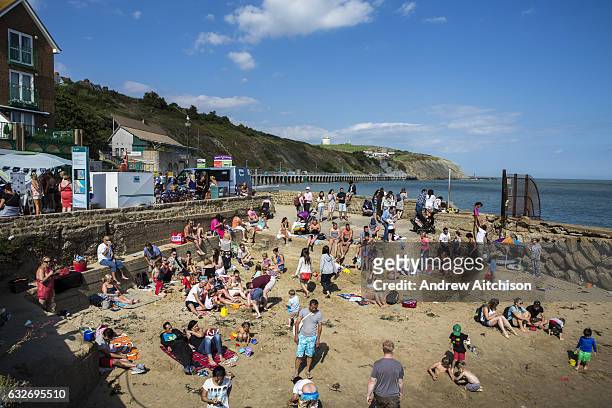 Lots of people play, relax and enjoy the sandy beach after the annual Trawler Race in Folkestone Harbour, Folkestone, Kent, England, United Kingdom.