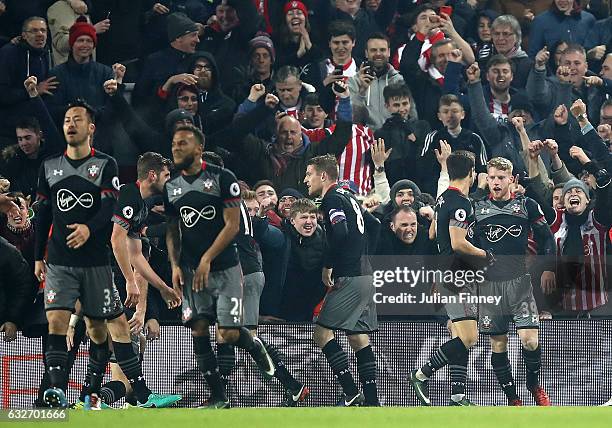 Shane Long of Southampton celebrates with team mates after scoring his sides first goal during the EFL Cup Semi-Final Second Leg match between...