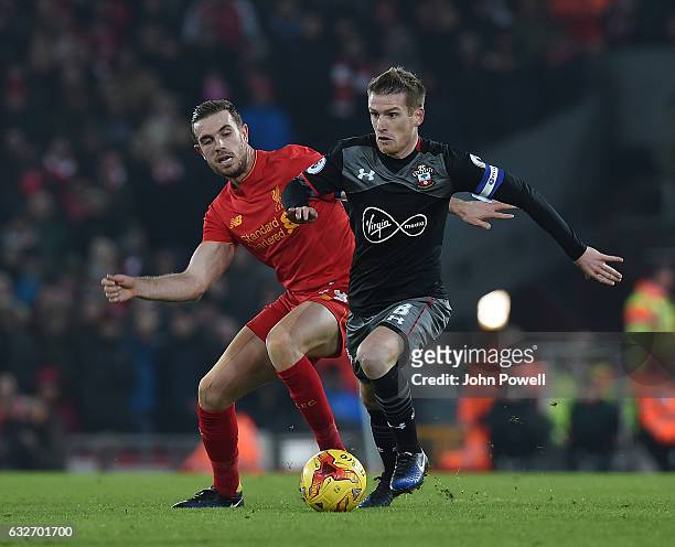 Jordan Henderson of Liverpool in action with Jack Stevens of Southampton during the EFL Cup Semi-Final second leg match between Liverpool and...