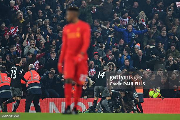 Southampton's Irish striker Shane Long is mobbed by teammates as he celebrates scoring his team's first goal during the EFL Cup semi-final second-leg...