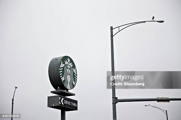 Signage is displayed outside a Starbucks Corp. Coffee shop in Peoria, Illinois, U.S., on Wednesday, Jan. 25, 2017. Starbucks Corp. Is expected to...