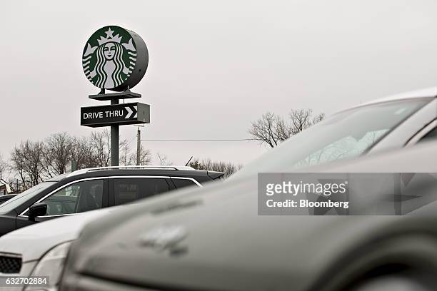 Signage is displayed outside a Starbucks Corp. Coffee shop in Peoria, Illinois, U.S., on Wednesday, Jan. 25, 2017. Starbucks Corp. Is expected to...