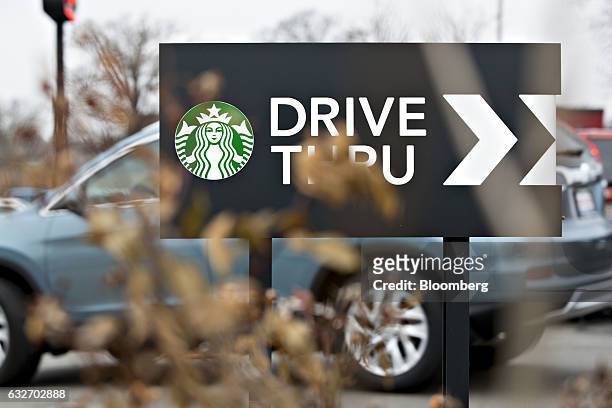 Logo is displayed on a drive thru sign outside a Starbucks Corp. Coffee shop in Peoria, Illinois, U.S., on Wednesday, Jan. 25, 2017. Starbucks Corp....
