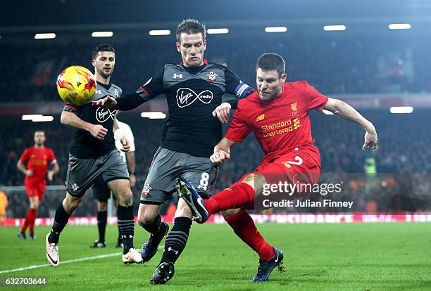 James Milner of Liverpool is closed down by Steven Davis of Southampton during the EFL Cup Semi-Final Second Leg match between Liverpool and...