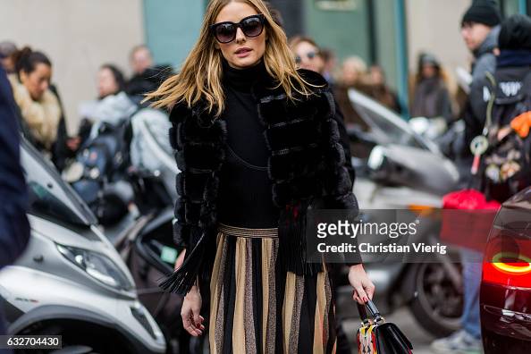 Olivia Palermo wearing a black fur jacket, striped skirt outside Elie ...