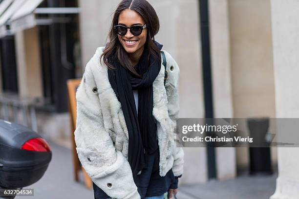 French model Cindy Bruna wearing a white fur jacket, black scarf, green bagpack outside Elie Saab on January 25, 2017 in Paris, Canada.