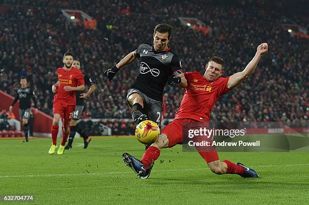 James Milner of Liverpool competes with Cedric of Southampton during the EFL Cup Semi-Final second leg match between Liverpool and Southampton at...