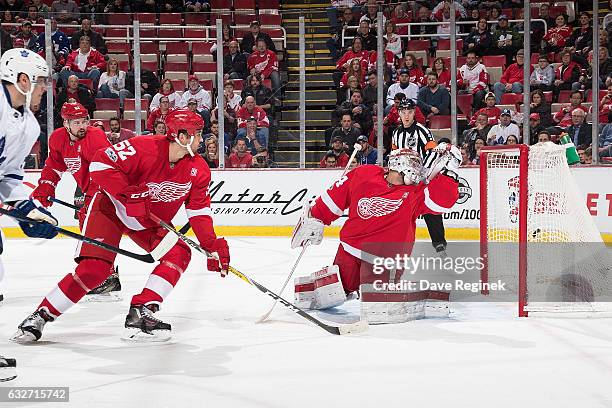 Auston Matthews of the Toronto Maple Leafs scores a first period goal past goaltender Petr Mrazek and defenseman Jonathan Ericsson of the Detroit Red...