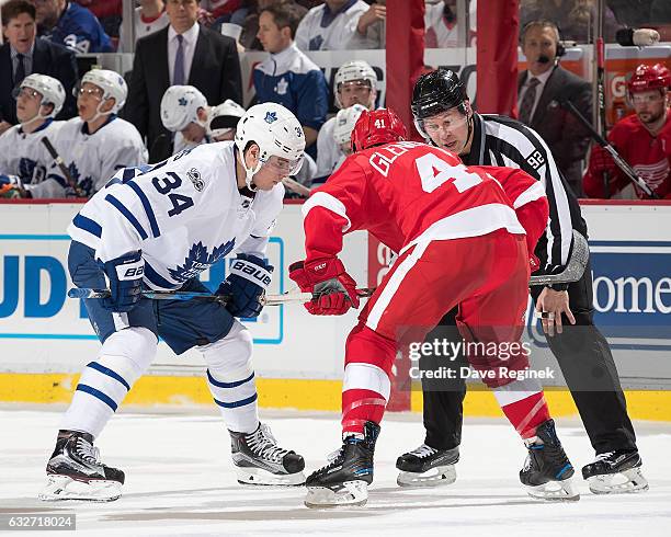 Linesman Mark Shewchyk drops the puck between Auston Matthews of the Toronto Maple Leafs and Luke Glendening of the Detroit Red Wings during an NHL...