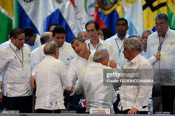 Dominican Republic President Danilo Medina shakes hand with Ecuadorean President Rafael Correa , next to Salvadoran President Salvador Sanchez Ceren...