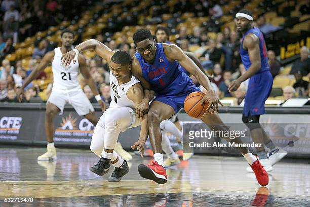 Taylor of the UCF Knights fouls Shake Milton of the SMU Mustangs during an NCAA basketball game at the CFE Arena on January 25, 2017 in Orlando,...