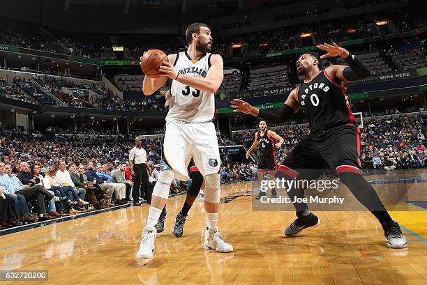 Marc Gasol of the Memphis Grizzlies handles the ball against Jared Sullinger of the Toronto Raptors during the game on January 25, 2017 at FedExForum...