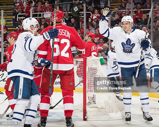 James van Riemsdyk of the Toronto Maple Leafs celebrates his third period goal with teammate Nikita Zaitsev in front of Jonathan Ericsson of the...