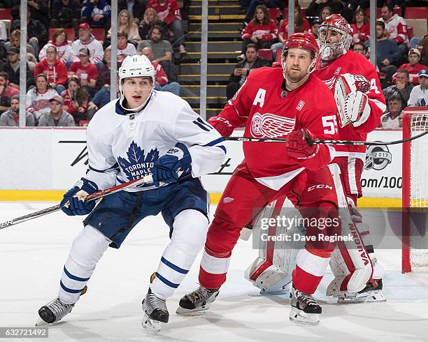 Niklas Kronwall of the Detroit Red Wings defends against Zach Hyman of the Toronto Maple Leafs in front of teammate goaltender Petr Mrazek of the...