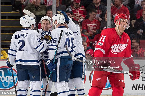 Roman Polak of the Toronto Maple Leafs celebrates his second period goal with teammates Matt Hunwick, Nazem Kadri, Leo Komarov and William Nylander...