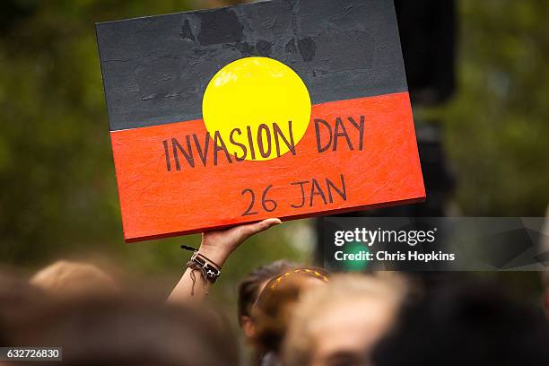 Protestor holds a sign during a march through Melbourne on January 26, 2017 in Melbourne, Australia. The march was organised to raise awareness of...