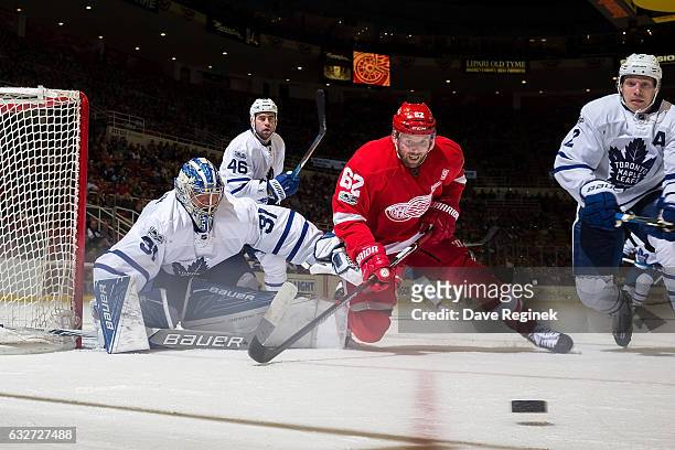 Thomas Vanek of the Detroit Red Wings battles for the puck with Matt Hunwick of the Toronto Maple Leafs in front of goaltender Frederik Andersen of...