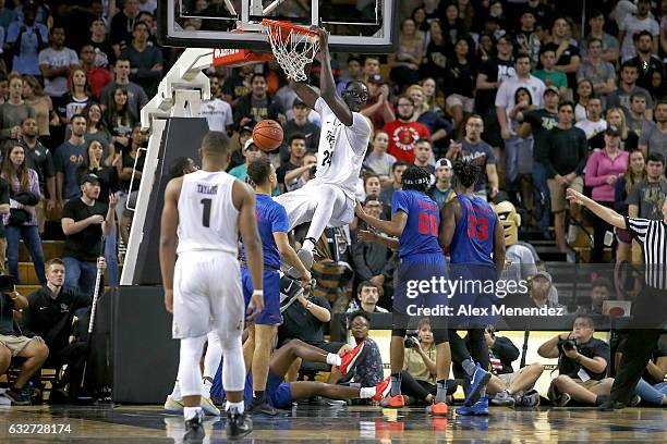 Tacko Fall of the UCF Knights slam dunks the ball in front of Ben Moore and Semi Ojeleye of the SMU Mustangs during an NCAA basketball game at the...