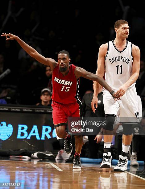 Okaro White of the Miami Heat celebrates his three point shot as Brook Lopez of the Brooklyn Nets reacts in the fourth quarter at the Barclays Center...