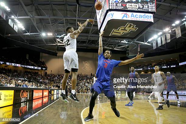 Matt Williams of the UCF Knights attempts a three-point shot over Sterling Brown of the SMU Mustangs during an NCAA basketball game at the CFE Arena...