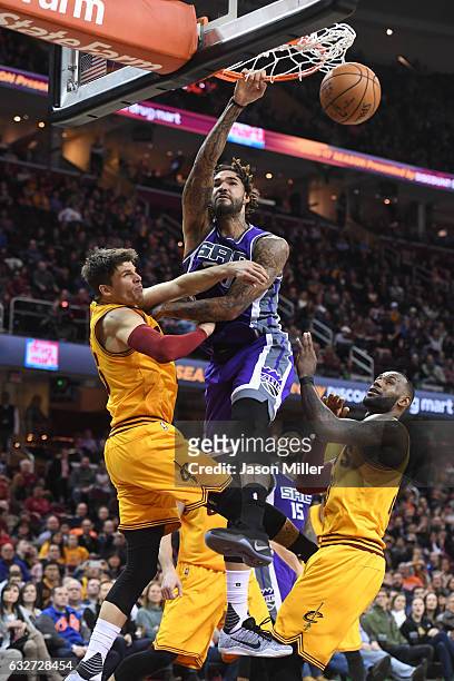 Willie Cauley-Stein of the Sacramento Kings dunks over Kyle Korver and LeBron James of the Cleveland Cavaliers during the second half at Quicken...
