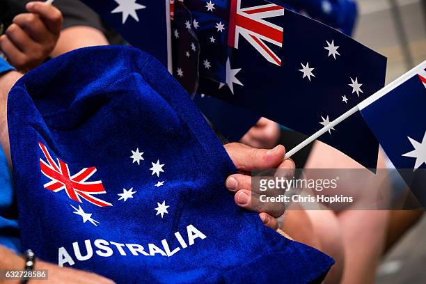 People wave flags and festive merchandise to celebrate Australia Day on January 26, 2017 in Melbourne, Australia. Australia Day, formerly known as...
