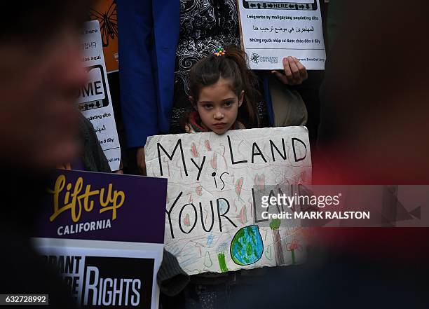 Maya Casillas joins migrant rights group during a vigil to protest against US President Donald Trump's new crackdown on "sanctuary cities", outside...