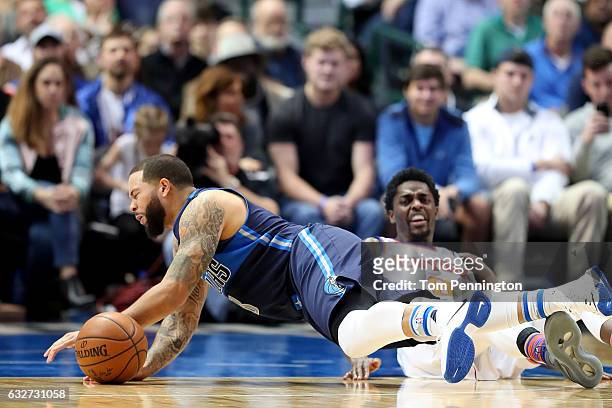 Deron Williams of the Dallas Mavericks collides with Justin Holiday of the New York Knicks in the first half at American Airlines Center on January...