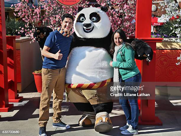 Guests pose with Po from the "Kung Fu Panda" film series at Universal Studios Hollywood on January 25, 2017 in Universal City, California.