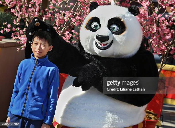 Boy poses with Po from the "Kung Fu Panda" film series at Universal Studios Hollywood on January 25, 2017 in Universal City, California.