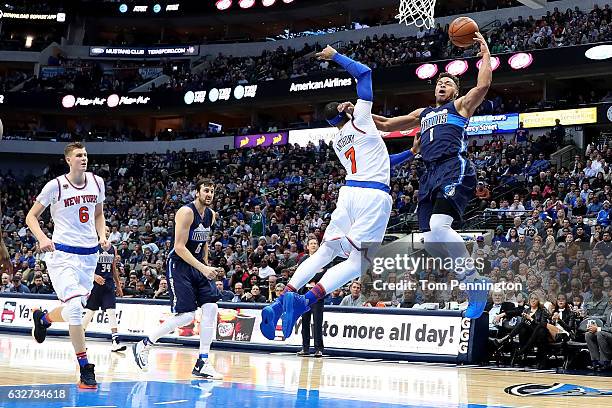 Justin Anderson of the Dallas Mavericks draws a foul against Carmelo Anthony of the New York Knicks in the second half at American Airlines Center on...