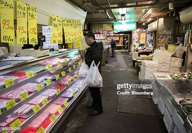 Customer shops for meat at a street market in Kitakyushu, Fukuoka, Japan, on Wednesday, Jan. 25, 2017. Japan is scheduled to release December...