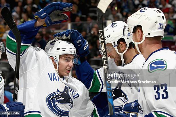 Troy Stecher of the Vancouver Canucks celebrates with Daniel Sedin and Henrik Sedin the go ahead goal in the third period against the Colorado...