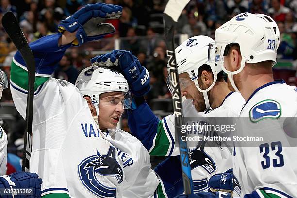 Troy Stecher of the Vancouver Canucks celebrates with Daniel Sedin and Henrik Sedin the go ahead goal in the third period against the Colorado...