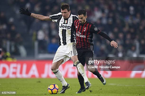 Mario Mandzukic of Juventus FC and Suso of AC Milan compete for the ball during the TIM Cup football match between Juventus FC and AC Milan. Juventus...