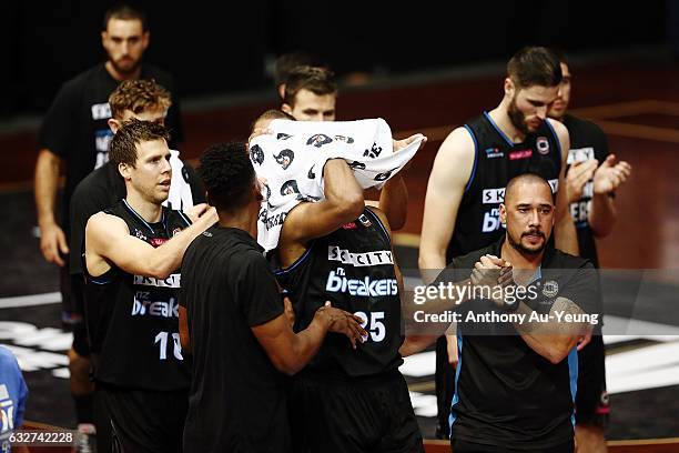 Akil Mitchell of the Breakers is helped off the court by his team with an eye injury during the round 17 NBL match between the New Zealand Breakers...