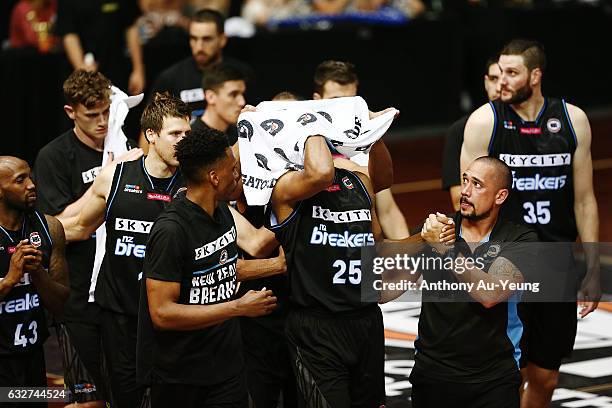 Akil Mitchell of the Breakers is helped off the court by his team with an eye injury during the round 17 NBL match between the New Zealand Breakers...