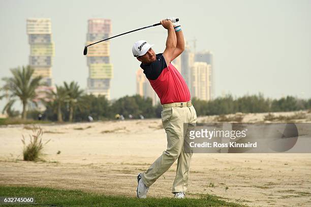 Graeme McDowell of Northern Ireland plays his second shot on the ninth hole during the first round of the Commercial Bank Qatar Masters at the Doha...