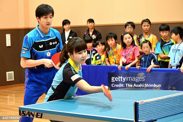 Ai Fukuhara And Chiang Hung-Chieh attend a table tennis class for children on January 25, 2017 in Matsuyama, Ehime, Japan.