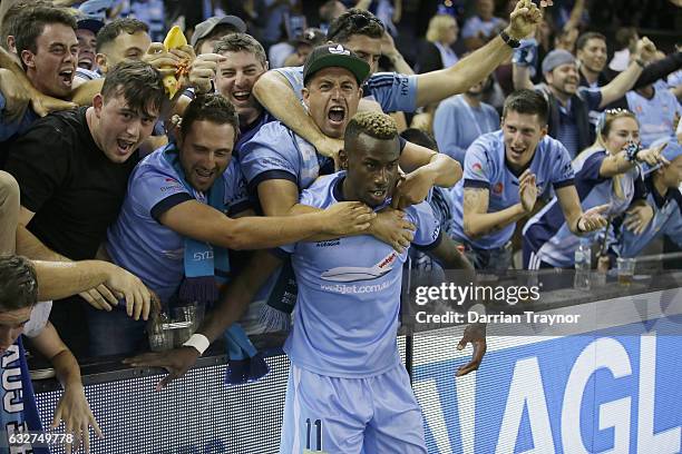 Bernie Ibini-Isei of Sydney FC celebrates a goal with fans during the round 17 A-League match between the Melbourne Victory and Sydney FC at Etihad...