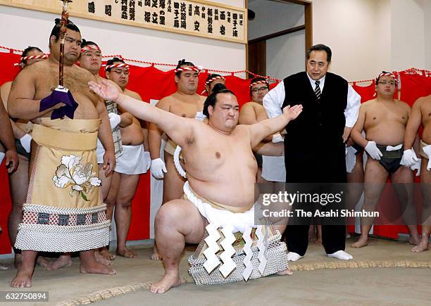 Newly promoted yokozuna Kisenosato practices the 'Dohyo-Iri' ring purification ritual instructed by former yokozuna Oonokuni, stable master...