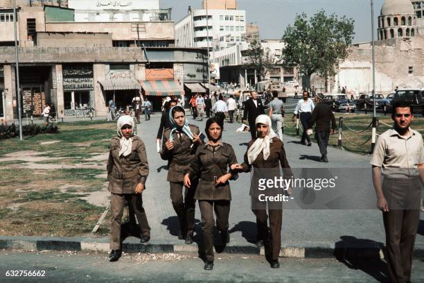 Female students in their uniforms walk in a street outside Damas University on October 22, 1973 during the ceasefire, called by The United Nations...
