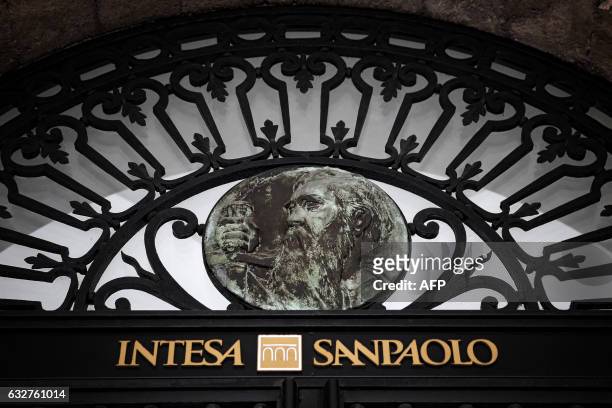 Picture taken on January 26, 2017 shows the Intesa Sanpaolo trademark on the historical headquarter of Intesa Sanpaolo bank in Piazza San Carlo in...