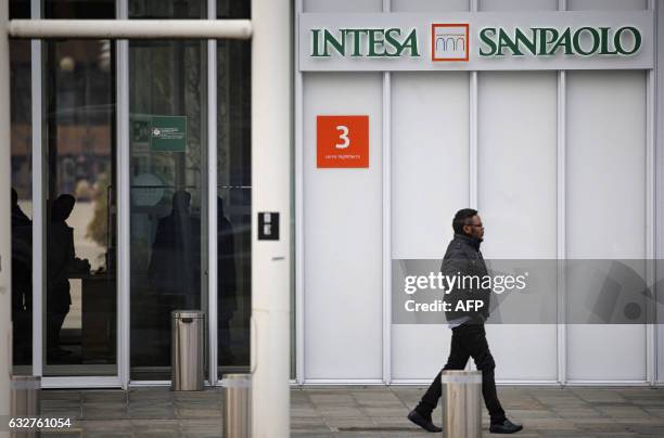 Man walks near the headquarters of Intesa Sanpaolo building on January 26, 2017 in Turin.