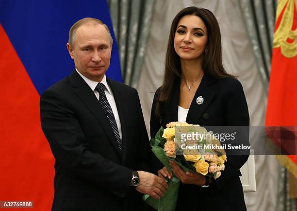 Russian President Vladimir Putin and singer Zara pose for a photo during an award ceremony at St. Catherine Hall of the Kremlin January 26, 2017 in...