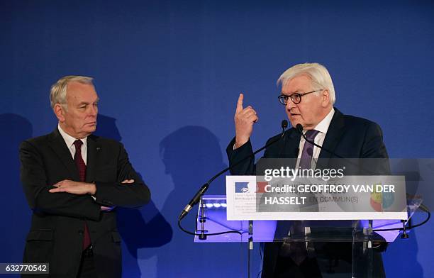 German Foreign Minister Frank-Walter Steinmeier gestures next to French Foreign Minister Jean-Marc Ayrault as he delivers a speech during the launch...